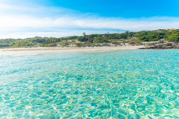 La Pelosa beach seen from the water on a sunny day