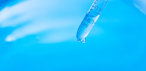 Wall Mural - beaker and water drop, science experiment,test tubes with blue liquid water samples and pipette over
