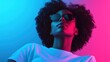 © svastix - A captivating woman with an afro hairstyle poses in trendy sunglasses, illuminated by vivid neon lights for a bold, fashionable look and modern feel.