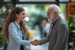 © Image Alchemy - Young business woman shaking hand with elderly doctor, Generative AI