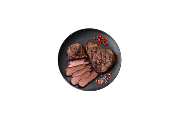 Wall Mural - Juicy beef steak grilled with salt, spices and herbs