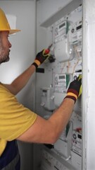 Wall Mural - Technician working on a modern electricity power meter station in a building.	
