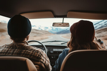 Couple enjoying a spontaneous road trip, exploring new places together.A man and a woman are comfortably sitting in the back seat of a car