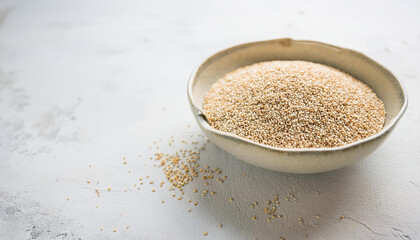 Quinoa seeds in ceramic bowl.