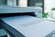 © Andrii - A close up view of a document being printed in a modern office setting during the day