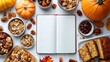 © olegganko - Autumn gathering with pumpkins, homemade treats, and a blank notebook for seasonal recipes