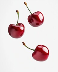 Wall Mural - Juicy cherries cascading against a bright white backdrop, celebrating sweet summer moments