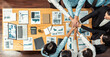 © InfiniteFlow - Panorama top view multiracial business people make synergy hand stack together over table with financial paper as analyst team building collaboration for corporate employee in workplace.Meticulous
