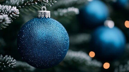 Sticker - Close-up of shimmering blue and silver Christmas ornaments hanging on a frosty tree, snow falling gently in the background 