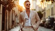 © Khalil - Handsome confident stylish hipster lambersexual model.Sexy modern man dressed in elegant beige suit. Fashion male posing in the street background in Europe city at sunset. In sunglasses
