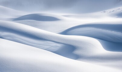 Abstract snowy plains with flowing patterns in the snow, highlighted by subtle winter light.