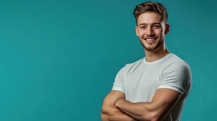 Smiling man with crossed arms, turquoise background