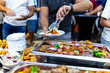 © zphoto83 - Culinary gathering at a food festival featuring diverse dishes and eager diners selecting their meals under evening lights