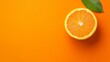 © Leli - A single orange slice lies against a vivid orange backdrop evoking freshness and vitality