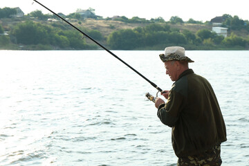 Sticker - Fisherman with rod fishing near lake at summer