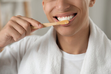 Poster - Young man brushing his teeth in bathroom, closeup