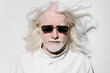 © SHOTPRIME STUDIO - Portrait of a mature man with long white hair and sunglasses, against a plain white background, conveying a futuristic and sophisticated vibe, highlighting style and confidence