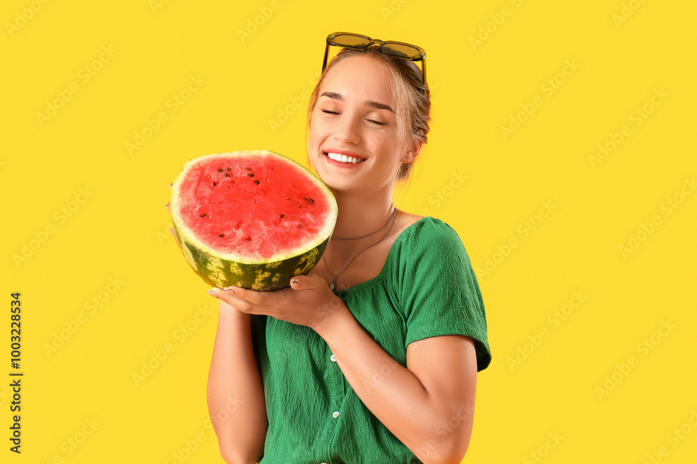 Young woman with fresh watermelon on yellow background