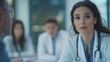 © Youttakone - A confident female doctor leading a team meeting in a hospital, with other healthcare professionals listening intently to her guidance