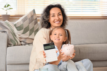 Poster - Little girl with her mother holding calculator and piggy bank at home