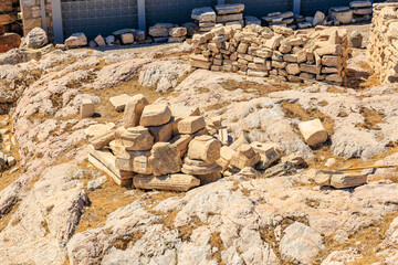 A pile of rocks sits on a rocky hillside