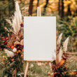 © Vitalii - Blank canvas mock up welcome signboard on a wooden easel decorated with flowers and pampas grass
