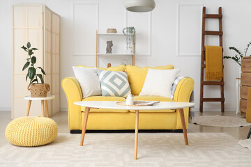 Sticker - Interior of living room with wooden ladder, yellow sofa and shelf unit