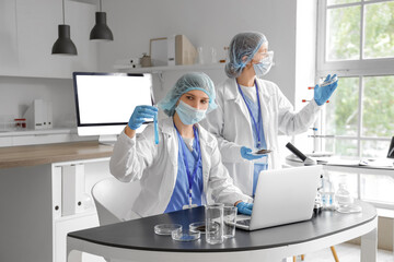 Canvas Print - Female scientists working with Petri dishes and test tube in laboratory