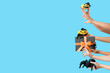 © Pixel-Shot - Female hands with Halloween gift, pumpkins and spiders on blue background