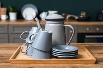 Wall Mural - Grey dishes on table in kitchen, closeup