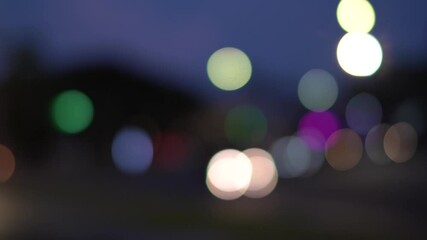night street lights blur bokeh of cars in traffic on the road at night. blurred abstract bright colo