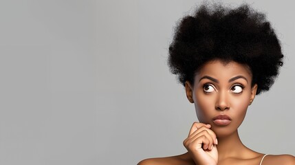 Wall Mural - Thoughtful black woman with afro looking to the side.