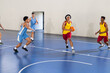 © Wavebreak Media - Playing basketball, athletes in action on indoor court during game