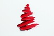 © InfiniteStudio - A festive red lipstick smear shaped like a Christmas tree on a clean, white background perfect for holiday celebrations and creative designs