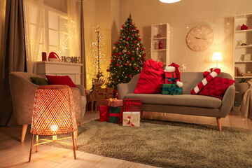 Canvas Print - Interior of living room with Santa bag and Christmas presents on sofa at night