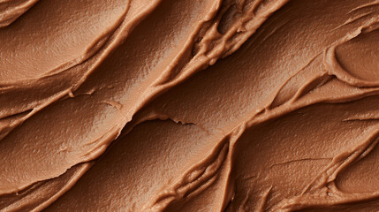 a close-up, top-down view of walnut paste spread across the frame, filling the image with its earthy brown color and smooth yet slightly grainy texture