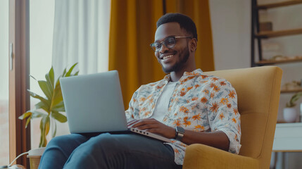 Poster - Young black freelancer smiling and using laptop while working from home office