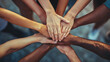© Andres Mejia - Diverse group of people joining hands in unity