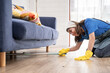 © Kawee - Asian young beautiful cleaner worker cleaning living room at home.
