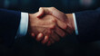 © Wonderful Studio - Close-up of two hands shaking, symbolizing trust and agreement, dark background.