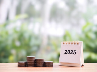 Wall Mural - 2025 desk calendar and stack of coins. The concept of business growth, Financial investment, Market stock, Profit return, Dividend and Business fund in year 2025