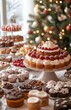 © yevgeniya131988 - Christmas cakes and sweets arranged on a table, with a blurred Christmas tree background