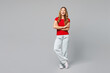 © ViDi Studio - Full body young smiling cheerful satisfied happy woman she wear red t-shirt casual clothes hold hands crossed folded look camera isolated on plain grey background studio portrait. Lifestyle concept.