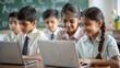 © N7 - Indian School Kids Using Laptops in a Classroom Against a Green Chalkboard Background Filled with Doodles