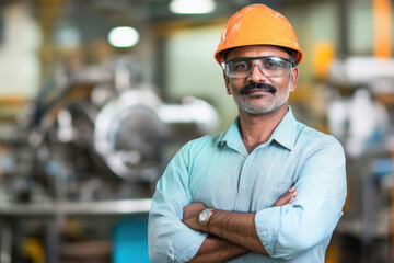 Indian male worker wearing a safety helmet and glasses