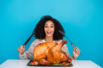 Canvas Print - Photo portrait of pretty young girl celebrate thanksgiving lick teeth excited cuttingdinner turkey isolated on blue color background