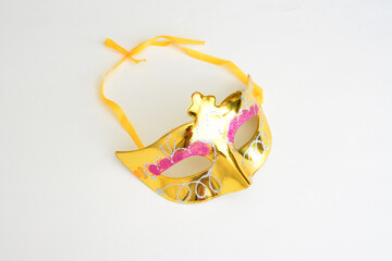 a golden carnival mask with a gold design on it isolated on white  