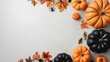 © masanyanka - A Creative Flat Lay of Halloween Pumpkins and Decorations with Blank Copy Space for a Festive Design