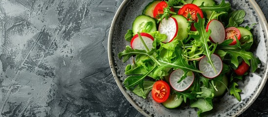 Fresh green salad with tomato cucumber and radish on a plate suitable for copy space image