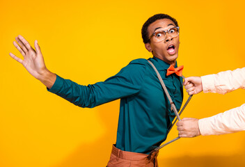 Poster - Photo of afraid man someone hands grab pull suspenders isolated vivid color background